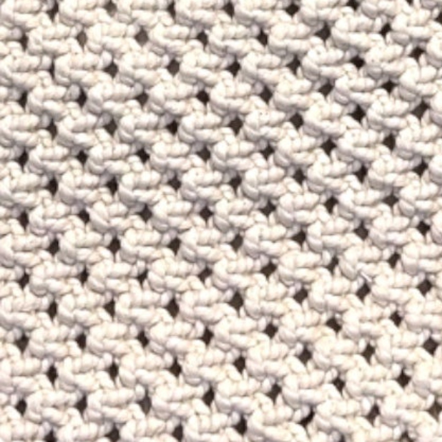 Close-up of beige macrame bag texture highlighting handcrafted weave and premium detail