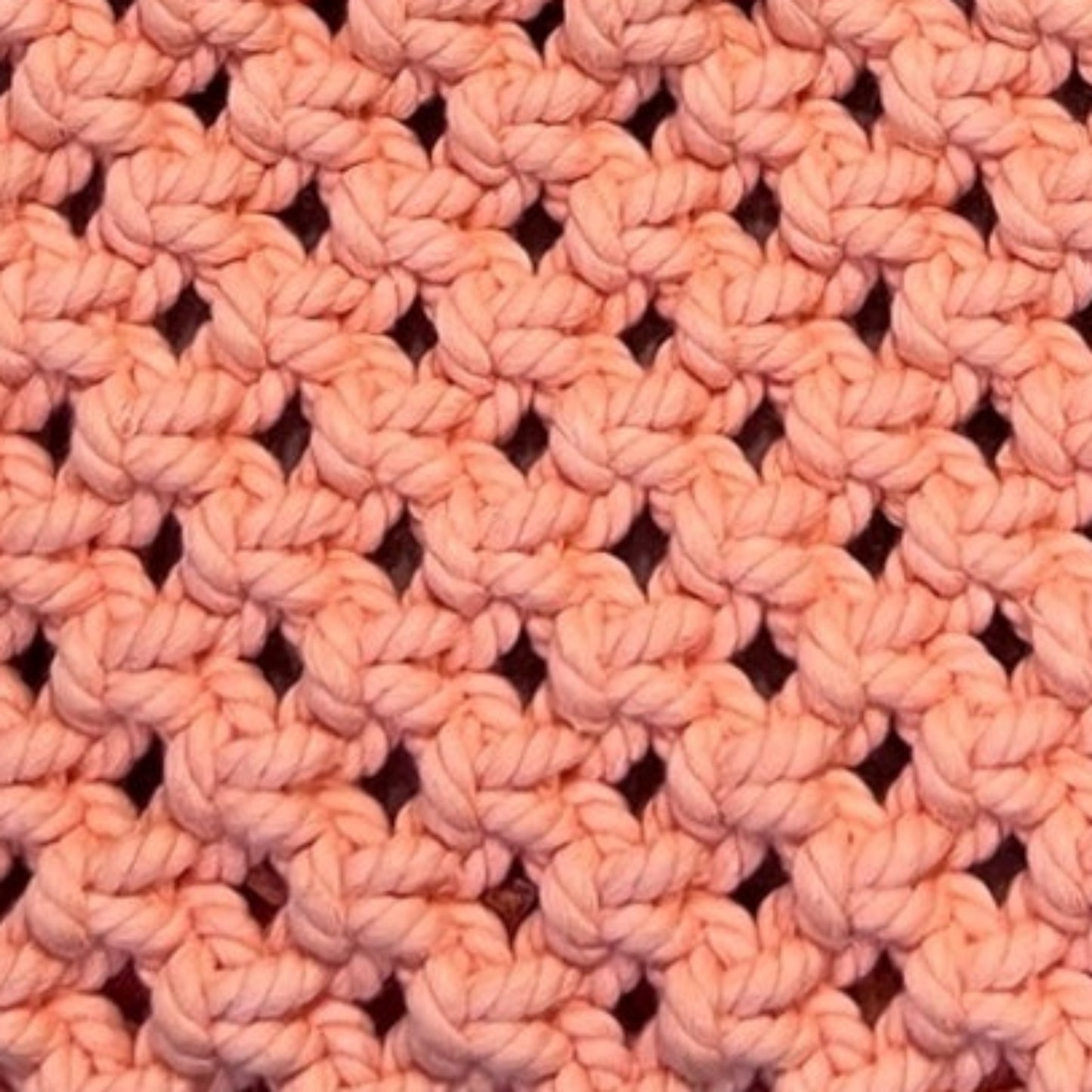 Close-up detail of peach blush macrame bag highlighting intricate handwoven texture and craftsmanship