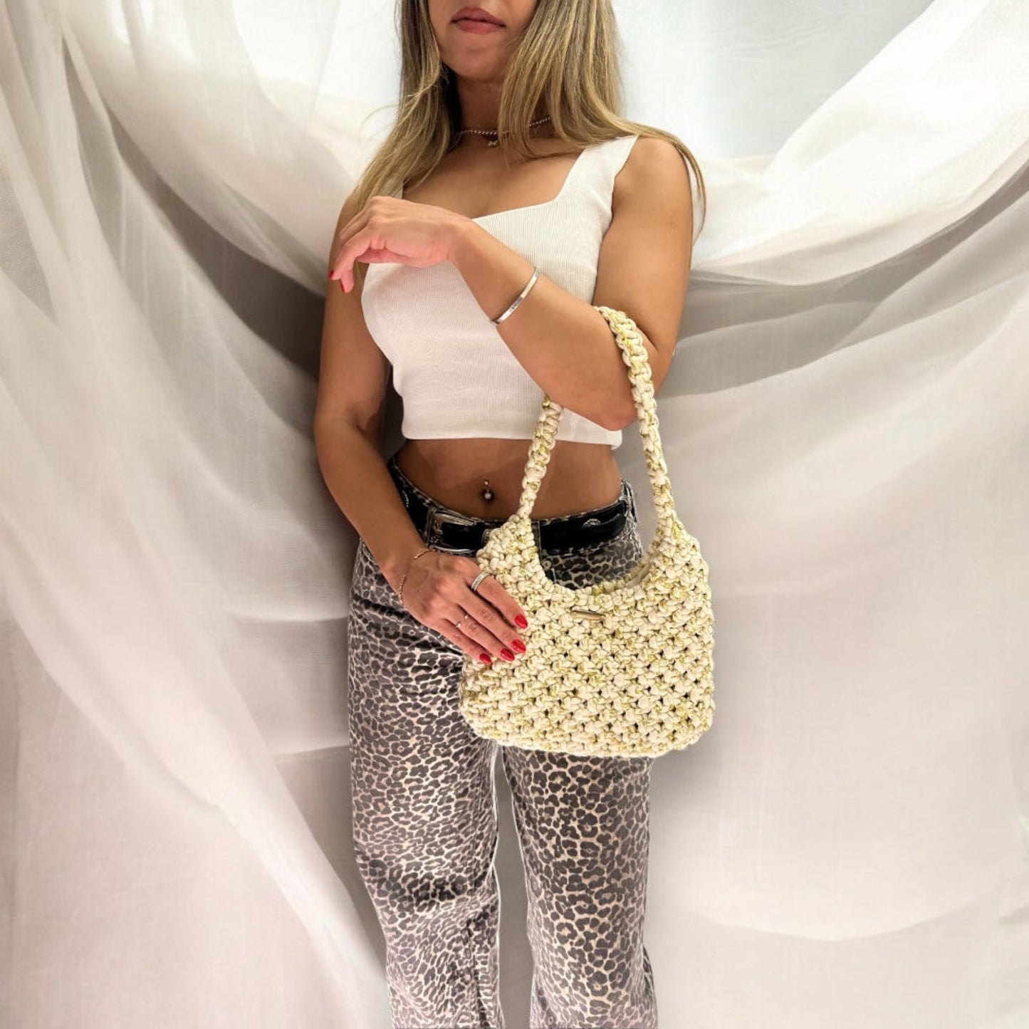 Handmade beige gold knit handbag with metallic detail, elegant half moon shoulder bag for women