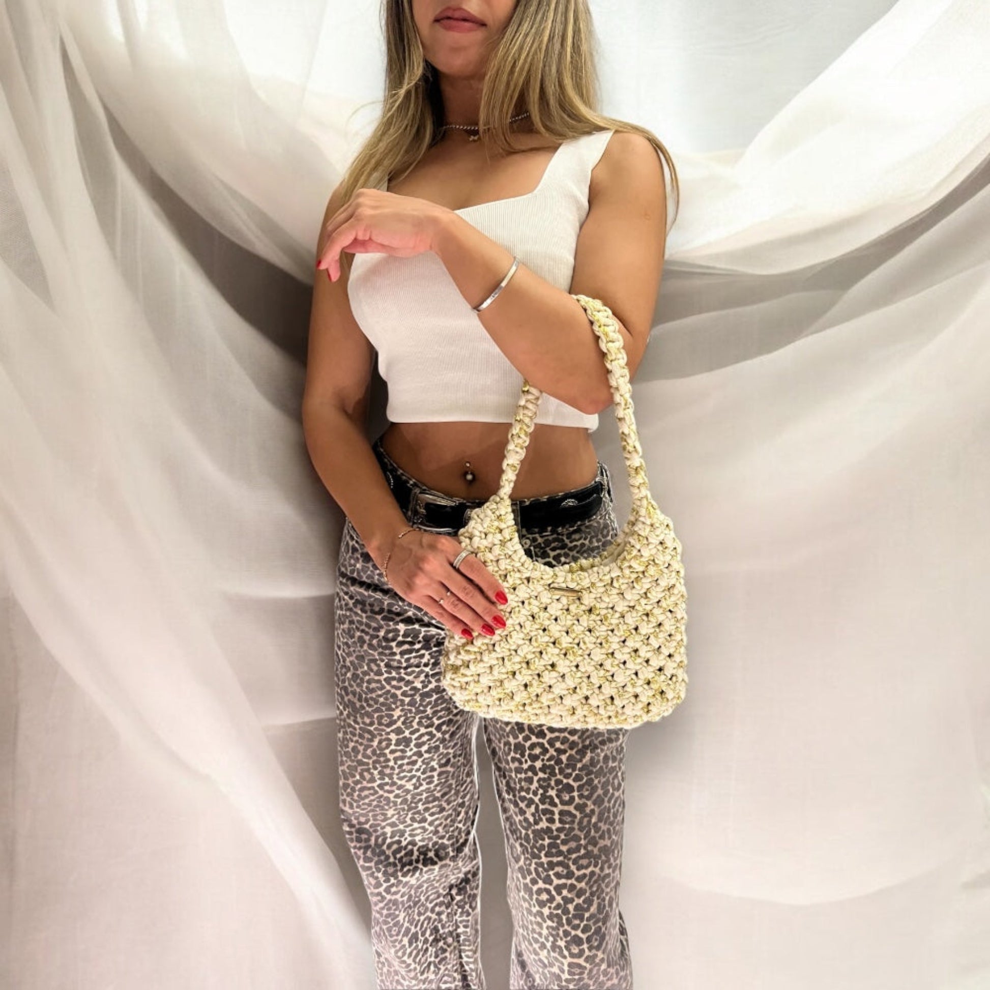 Handmade beige gold knit handbag with metallic detail, elegant half moon shoulder bag for women