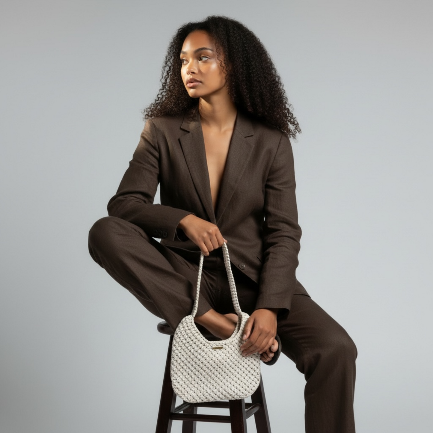 Beige macrame bag paired with neutral outfit, sophisticated everyday style