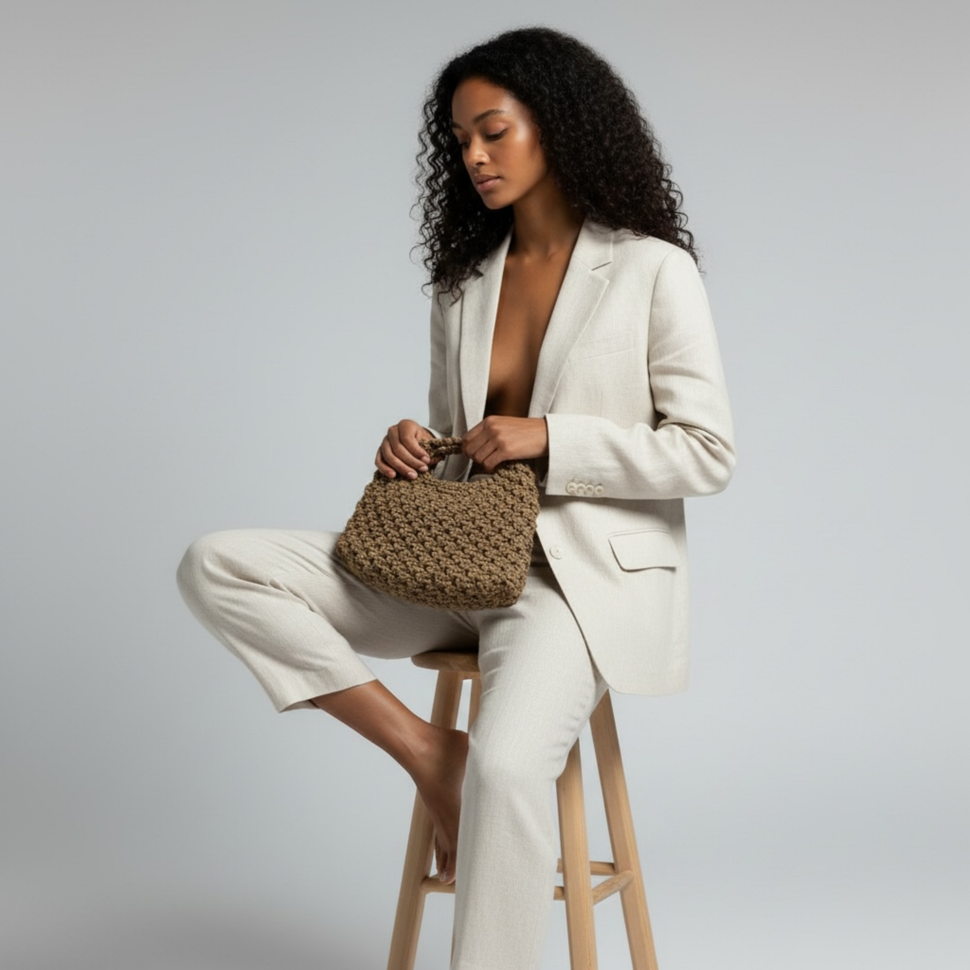Caramel brown handmade macrame bag paired with modern minimalist suit in motion