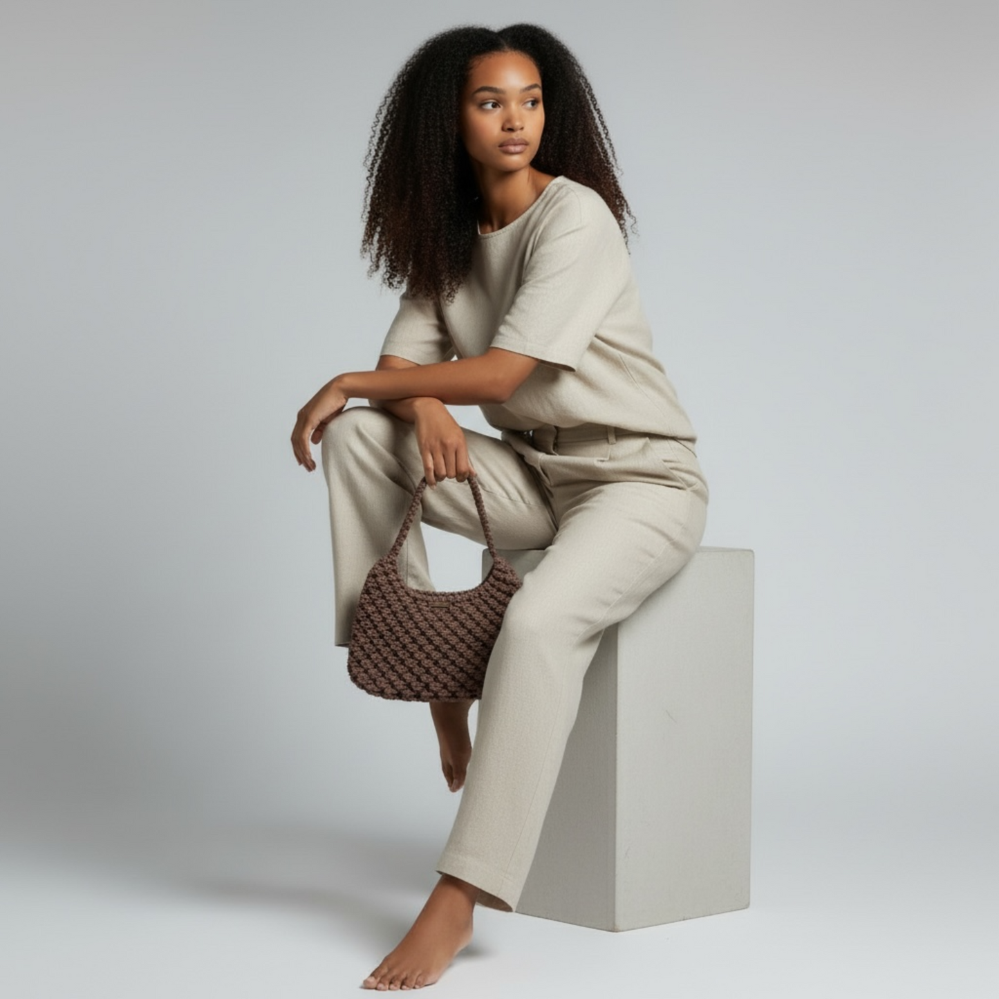 Handmade dusty cocoa woven bag styled with soft beige outfit, modern boho look