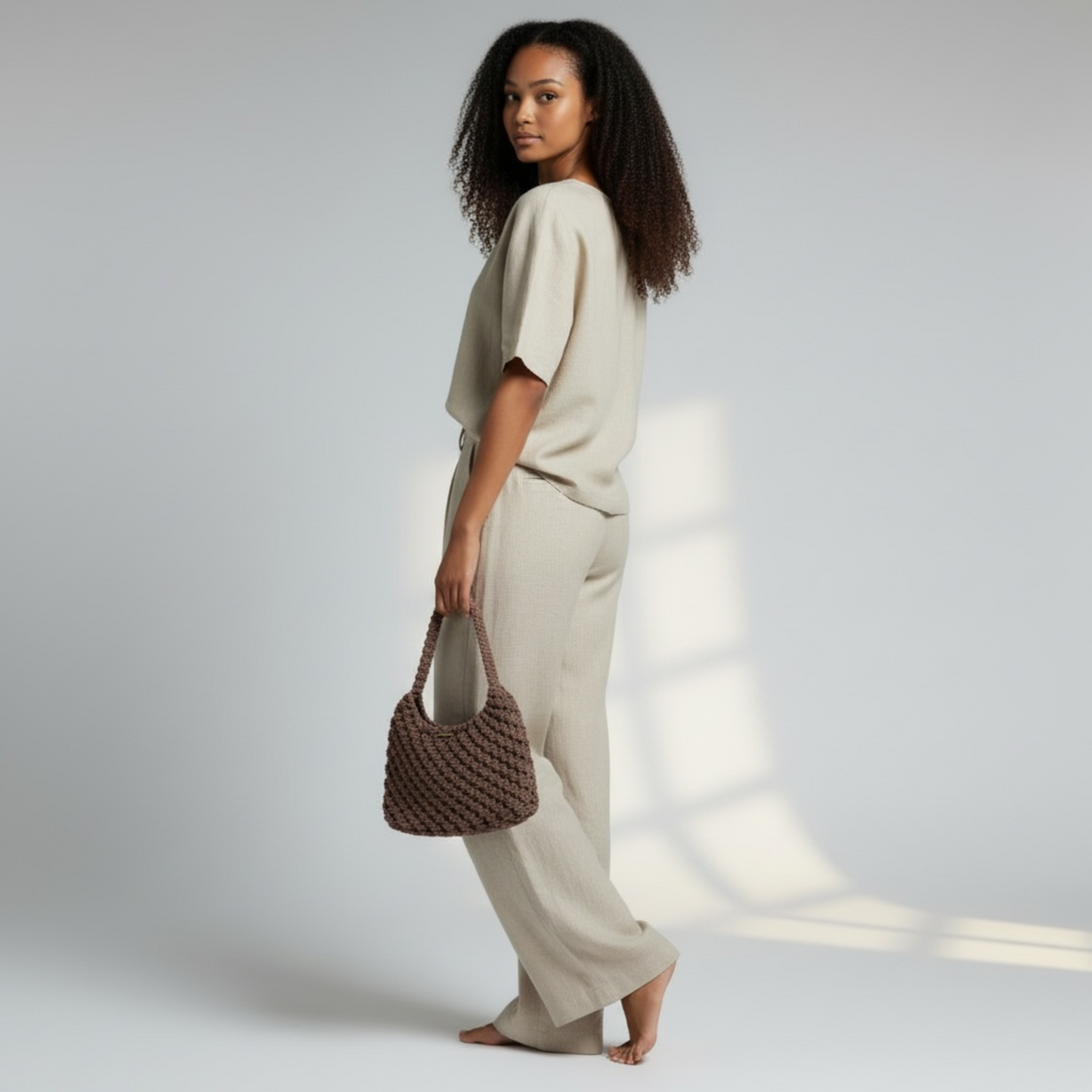 Side view of dusty cocoa shoulder bag paired with relaxed neutral clothing