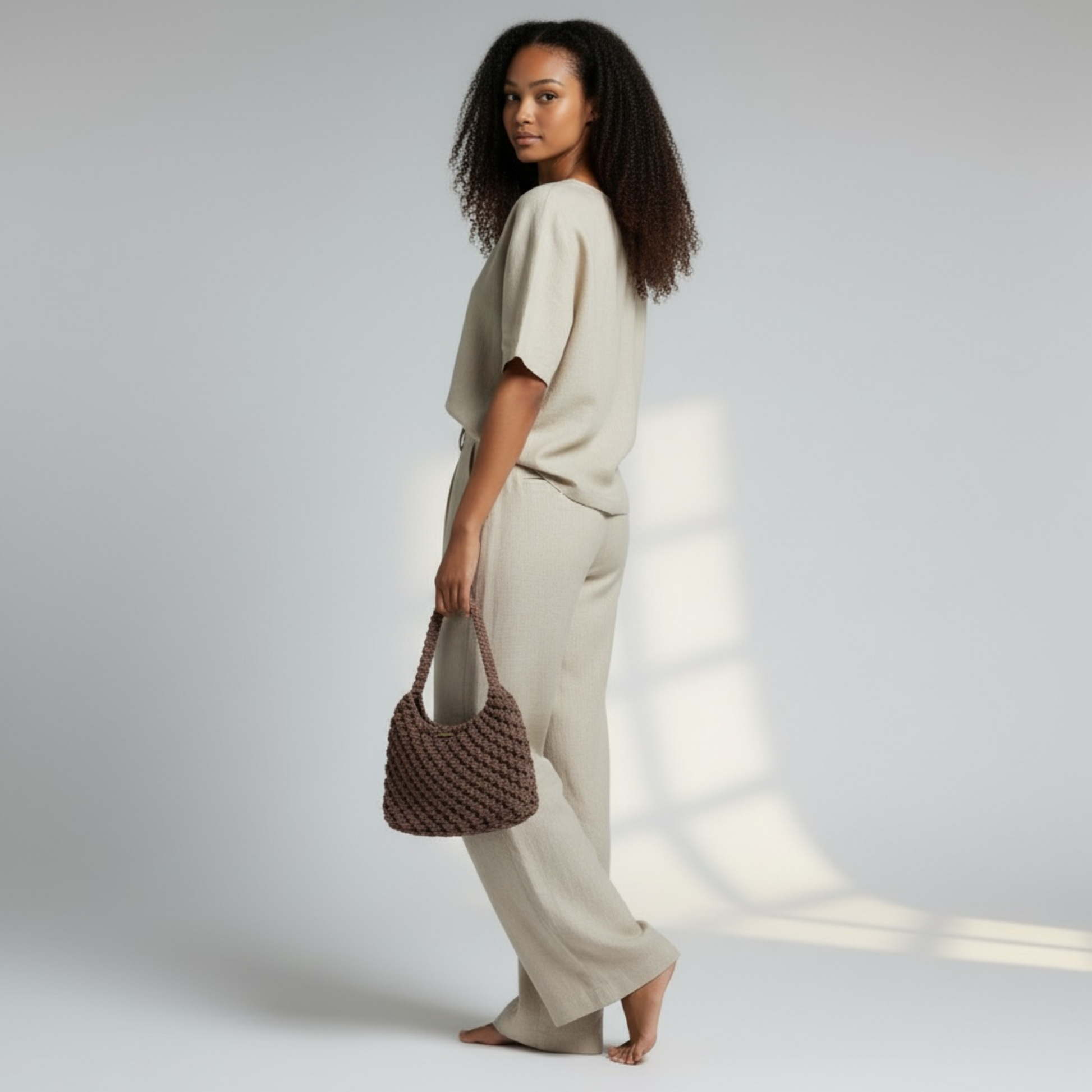 Side view of dusty cocoa shoulder bag paired with relaxed neutral clothing