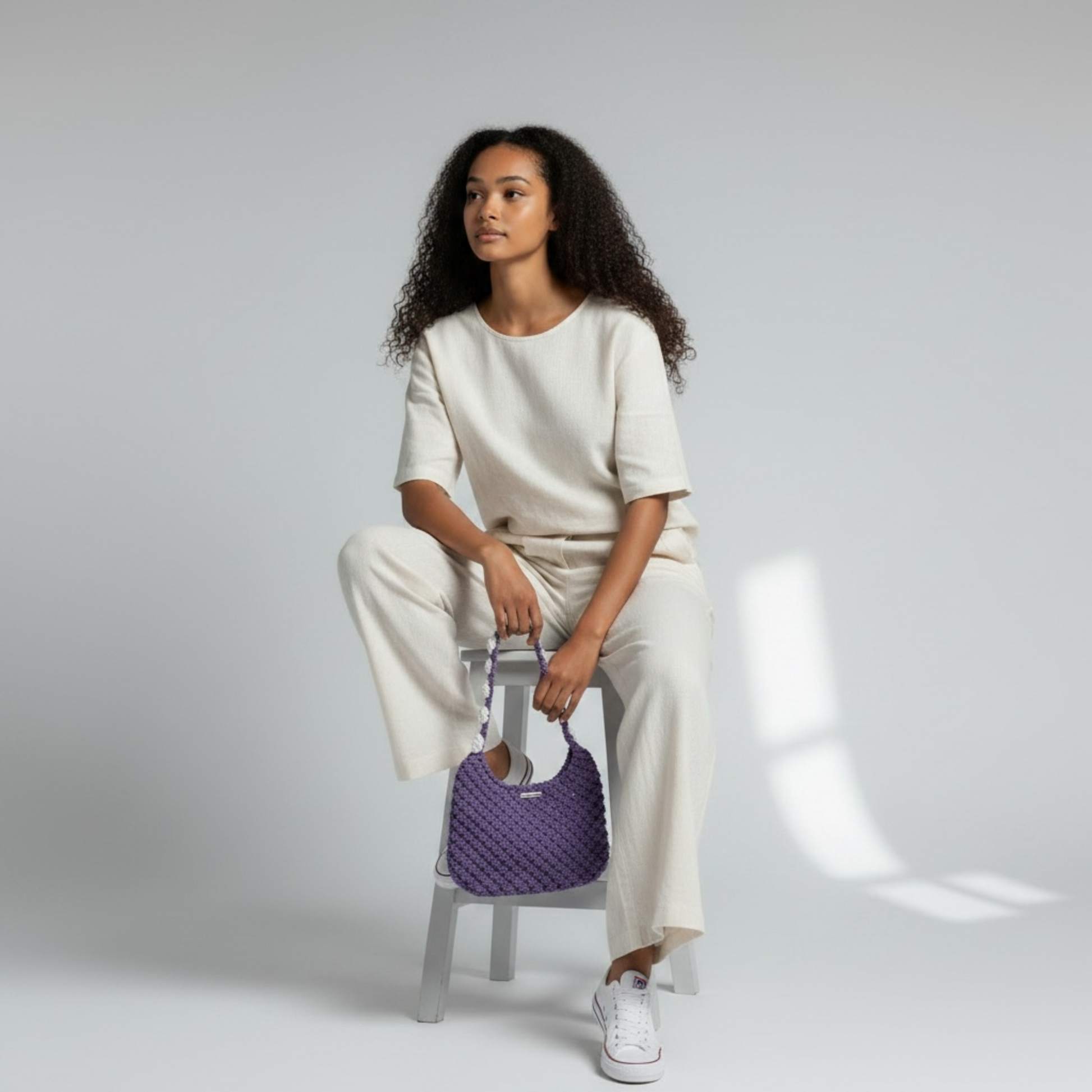 Minimalist dusty lavender half moon bag worn crossbody, modern feminine handbag