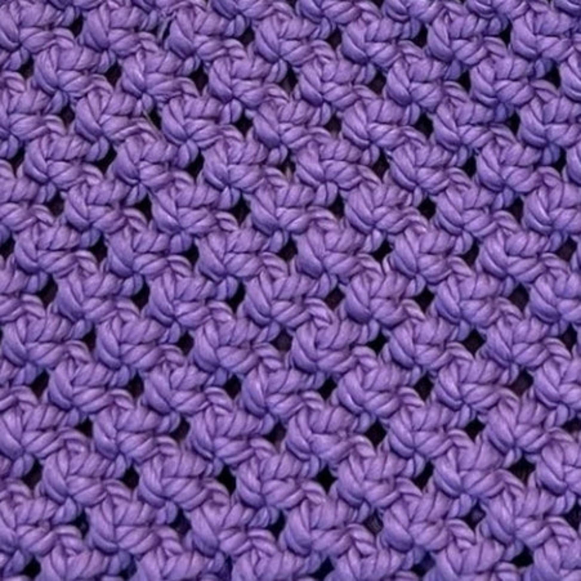 Textured crochet pattern in dusty lavender, handmade macrame bag detail close-up