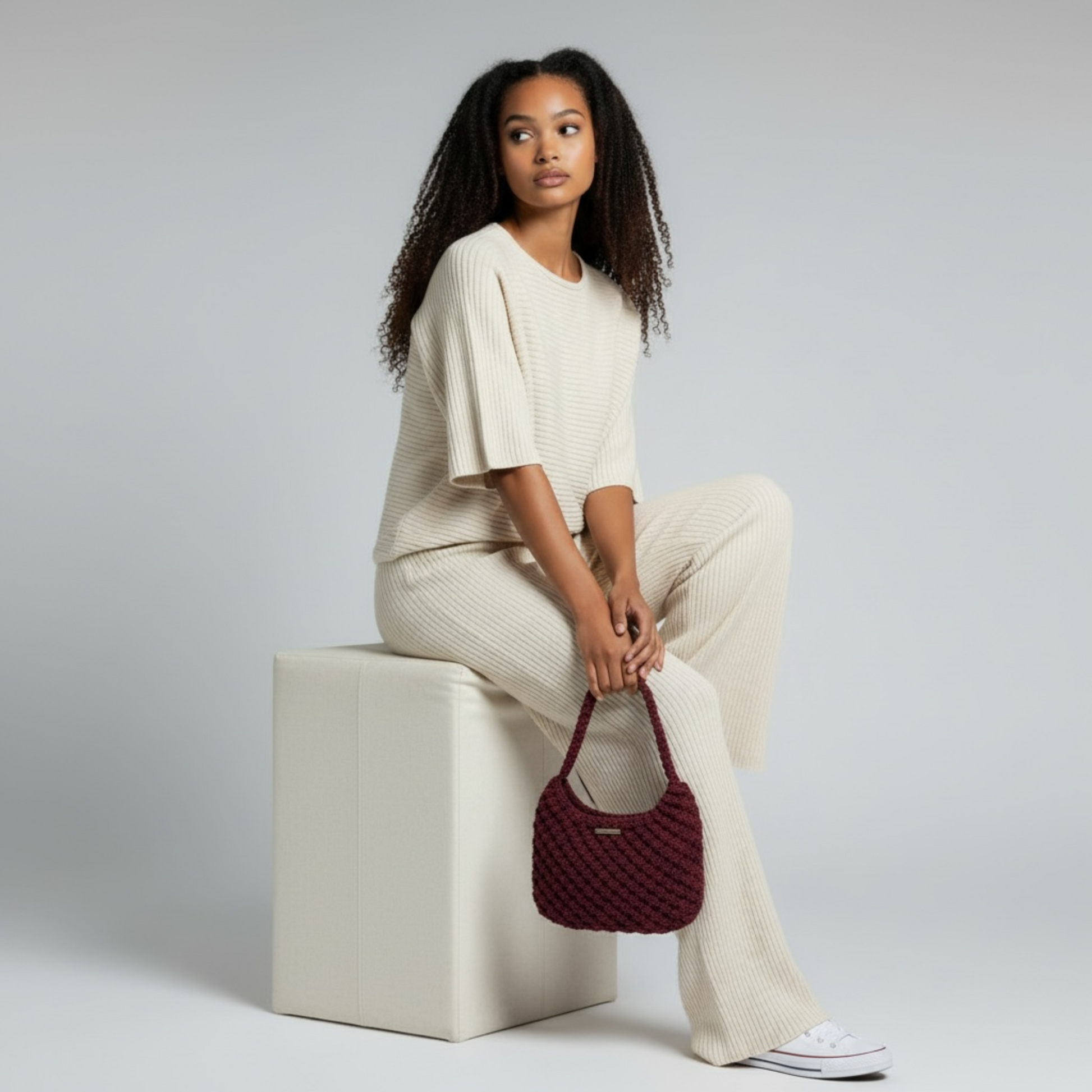 Merlot plum textured macrame shoulder bag paired with modern minimalist outfit