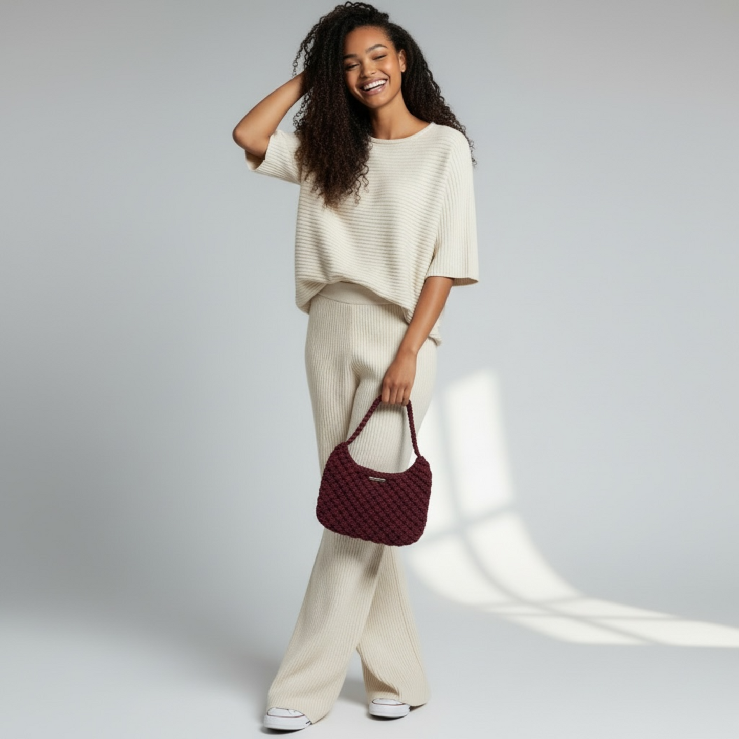 Close-up of handmade merlot plum macrame bag with structured half moon silhouette