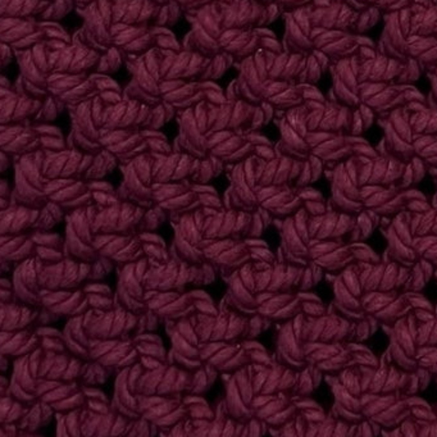 Close-up detail of merlot plum macrame bag showcasing intricate handwoven texture and craftsmanship