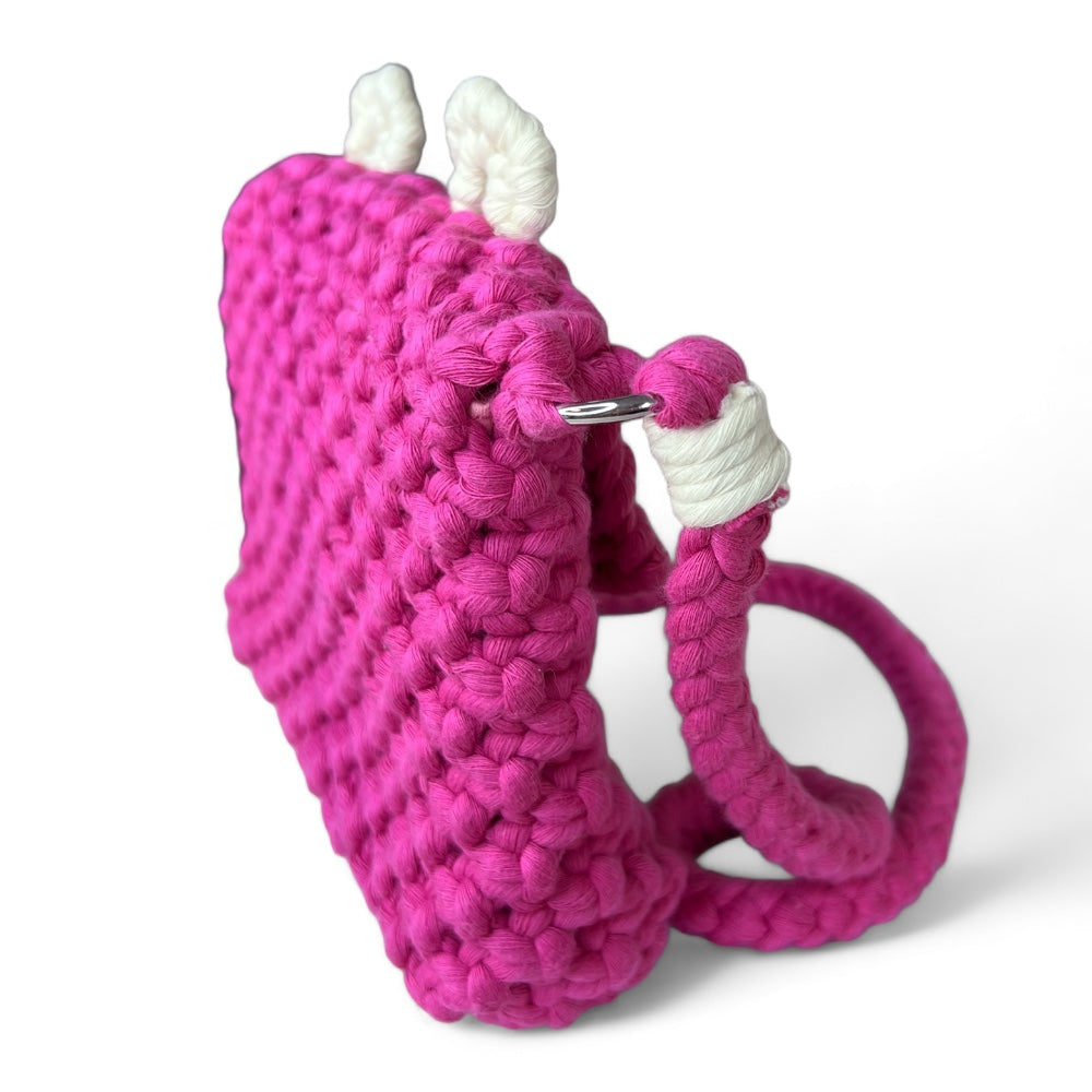 Side view of the Berry Bear macrame crossbody bag showing its structured depth, strap attachment and silver-tone ring.