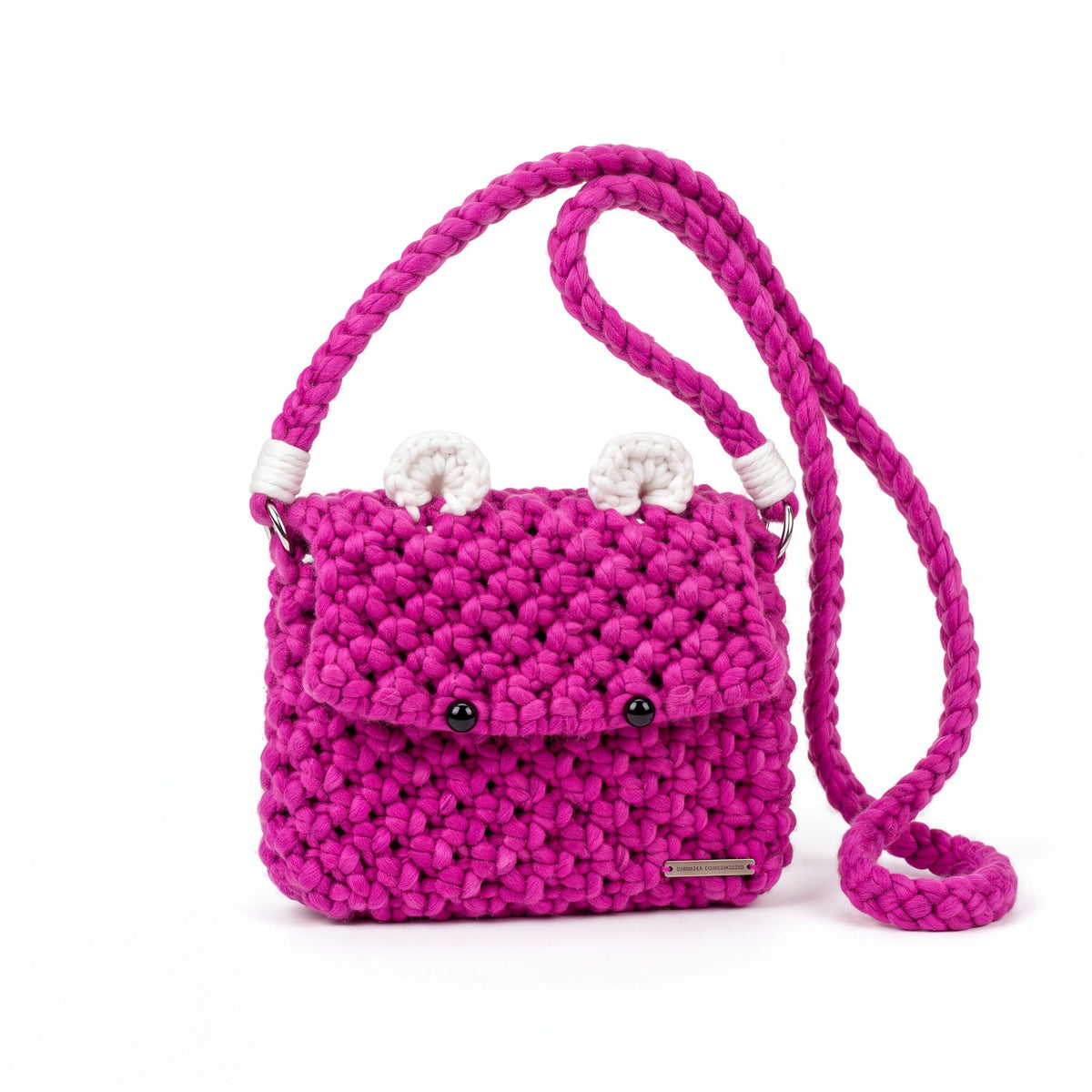 Close-up of the chunky cotton macrame texture, curled white ears, black bead eyes and silver-tone hardware on the Berry Bear bag.